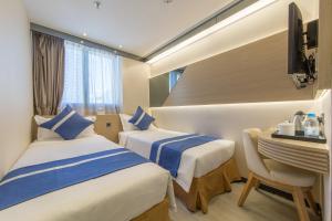 En eller flere senger på et rom på Lumine Hotel
