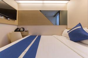 En eller flere senger på et rom på Lumine Hotel