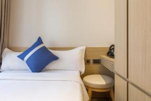 En eller flere senger på et rom på Lumine Hotel