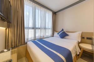 En eller flere senger på et rom på Lumine Hotel