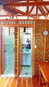 a person taking a picture of a bathroom in a house at MJ Room Rental Mahogany in Dauis