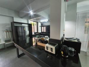 a kitchen with a counter with a toaster on it at Loyy Hotel in Chiang Mai