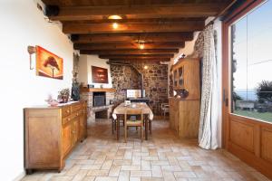 a kitchen with a table and a dining room at Casa Silvia ll in Torri del Benaco +20 photos