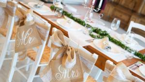 einen Tisch mit weißen Tellern und Stühlen mit Schildern in der Unterkunft Haus Grünewald Unsleben in Unsleben