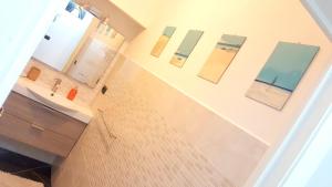a bathroom with a sink and mirrors on the wall at Casa del Sole - Sunshine Home in Marina di Pisa