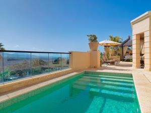 a swimming pool with a view of a house at Royal Garden Villas, Luxury Hotel in Adeje