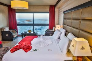 a bedroom with a bed with a view of the ocean at Riad Mimouna in Essaouira