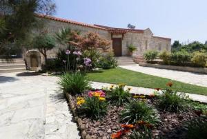a garden with flowers in front of a building at Villa Chara Chania in Agia Marina Nea Kydonias