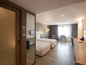 Voodi või voodid majutusasutuse Fortune View Khong Hotel Nakhon Phanom toas