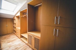 a walk in closet with wooden cabinets and a skylight at No:19 Boutique Hotel in Ankara