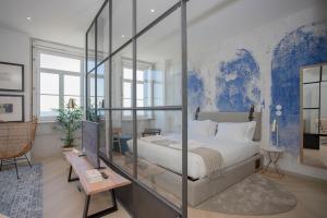 a bedroom with a large bed with a glass wall at Liiiving in Porto - Luxury Beachfront Apartments in Porto