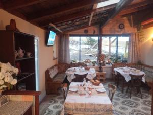 a living room with two tables and a couch at Gasthaus Rübenau in Rübenau