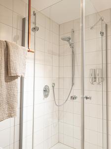 a bathroom with a shower with a glass door at Design Apartment am Wasserbachhof in Lemgo