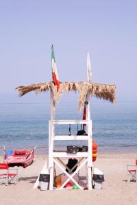 a lifeguard tower on a beach with the ocean at Sole Mare Deluxe in Campofelice di Roccella