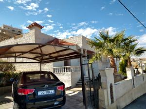 a car parked under a shelter in front of a house at Horizon in Wadi Musa +2 photos