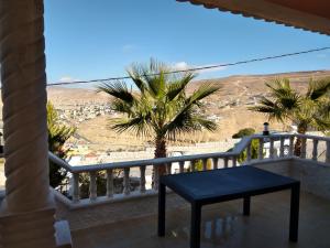 a balcony with a table and a view of the desert at Horizon in Wadi Musa