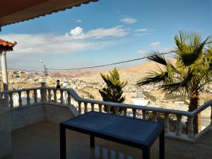a balcony with a bench and a view of the city at Horizon in Wadi Musa