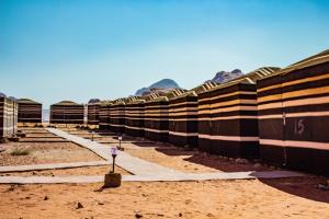 a row of black and white buildings in the desert at Quite bedouin life in Wadi Rum