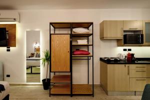 a room with a kitchen with a shelf in it at Jacuzzi By The Historic Giza Pyramids - Apartment 3 in Cairo