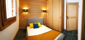 En eller flere senge i et værelse på ODYSSEE A203 Charmant appartement sur les pistes