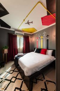 a bedroom with a large bed with red and yellow ceilings at The Terminal 1 Stay - Steps From Nightlife and Airport in Cairo