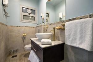 a bathroom with a sink and a toilet at Jacuzzi By The Historic Giza Pyramids - Apartment 2 in Cairo