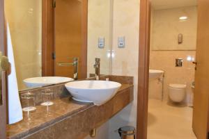 a bathroom with a sink and a mirror at Al Khoory Executive Hotel, Al Wasl in Dubai