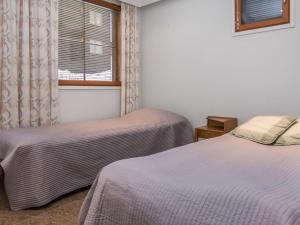 a room with two beds and a window at Holiday Home Karhunvartijan linna b14 by Interhome in Ruka +8 photos