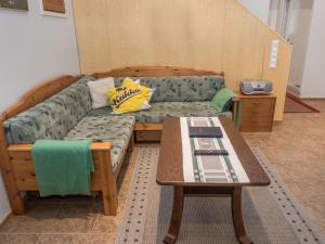 a living room with a couch and a table at Holiday Home Karhunvartijan linna b14 by Interhome in Ruka
