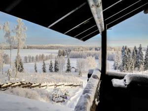 a room with a view of a snow covered field at Holiday Home Härkälinna by Interhome in Hauho