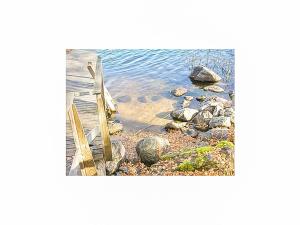 a picture of the ocean with rocks in the water at Holiday Home Karhunluola by Interhome in Hauho