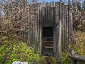 a wooden outhouse in the middle of a field at Holiday Home Härkälinna by Interhome in Hauho