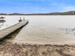 a dock on a lake with trees in the background at Holiday Home Puolukka by Interhome in Hauho