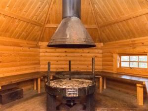 a kitchen in a log cabin with aendant light at Holiday Home Lakka by Interhome in Hauho
