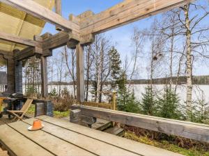 a wooden pavilion with a view of a lake at Holiday Home Puolukka by Interhome in Hauho