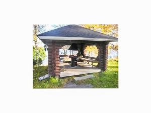 a gazebo with a picnic table in the grass at Holiday Home Karhunluola by Interhome in Hauho +20 photos