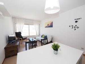 a kitchen and living room with a table and chairs at Apartment Roger de Flor-1 by Interhome in Llança +14 photos