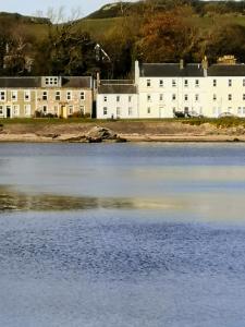 a building on the shore of a body of water at Beside the Bay in Millport