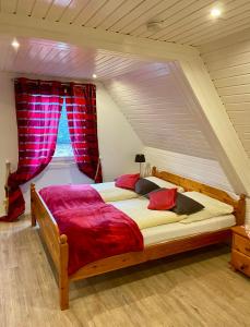 a bedroom with a large bed in a attic at Landgasthaus Alter Posthof in Halsenbach