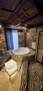 a zebra themed bathroom with a tub in the middle at Casona Camino Real De Selores in Selores