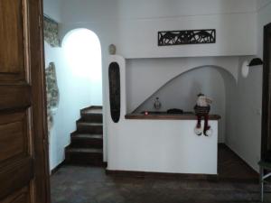 a stairway with a figurine on a shelf in a room at B&B Piazza San Benedetto in Militello in Val di Catania