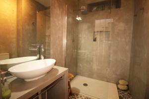 a bathroom with a white sink and a shower at A Casa Lagos, City in Lagos