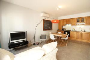 a living room with a couch and a table and a tv at A Casa Lagos, City in Lagos +7 photos