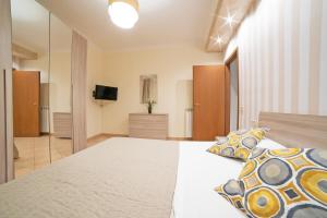 a bedroom with a large bed and a television at B&B del Sole in Ercolano