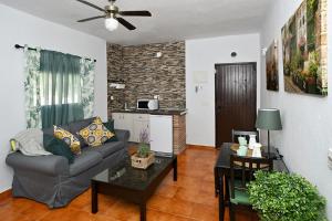 a living room with a couch and a table at FINCA VILLA MARINA in Málaga