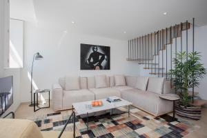 a living room with a couch and a table at Liiiving in Porto - Luxury Beachfront Apartments in Porto