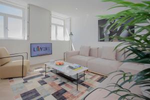 a living room with a couch and a coffee table at Liiiving in Porto - Luxury Beachfront Apartments in Porto
