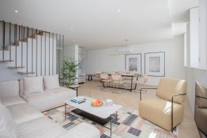 a living room with a couch and a table at Liiiving in Porto - Luxury Beachfront Apartments in Porto