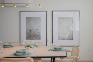 a dining room with a table and a bike on the wall at Liiiving in Porto - Luxury Beachfront Apartments in Porto