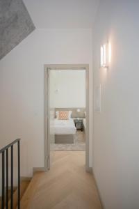 a hallway with a door leading to a bedroom at Liiiving in Porto - Luxury Beachfront Apartments in Porto
